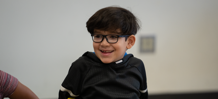 Happy older elementary school boy prepared to begin phonics lesson using manipulatives