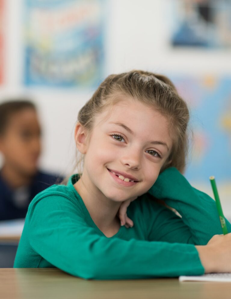 Student writing in classroom