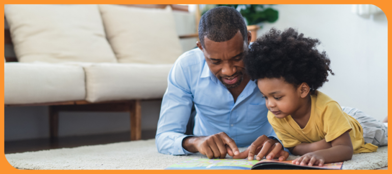 Dad reading on floor with young son