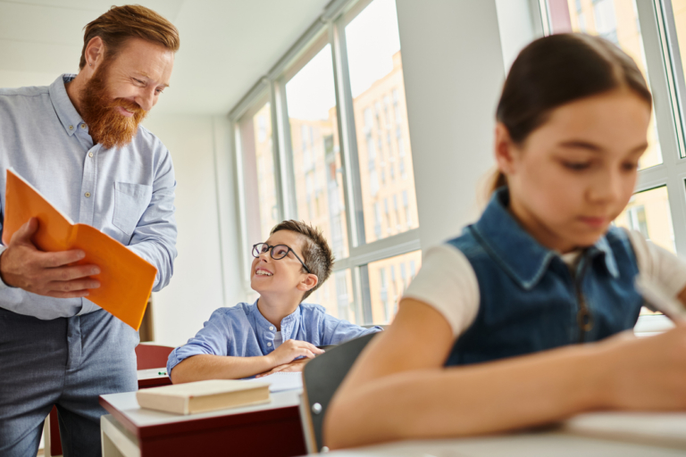 Engaging teacher interacts with pupils in bright classroom during learning session